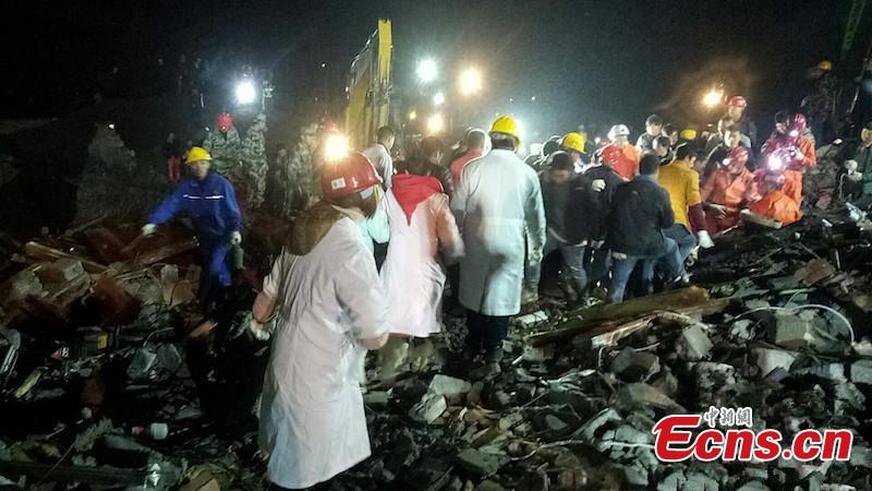 Rescuers race against time pulling buried people out of debris after a landslide topped three houses in Xuyong county, Sichuan province, on Sunday. (Photo: China News Service/ Su Zhongguo)