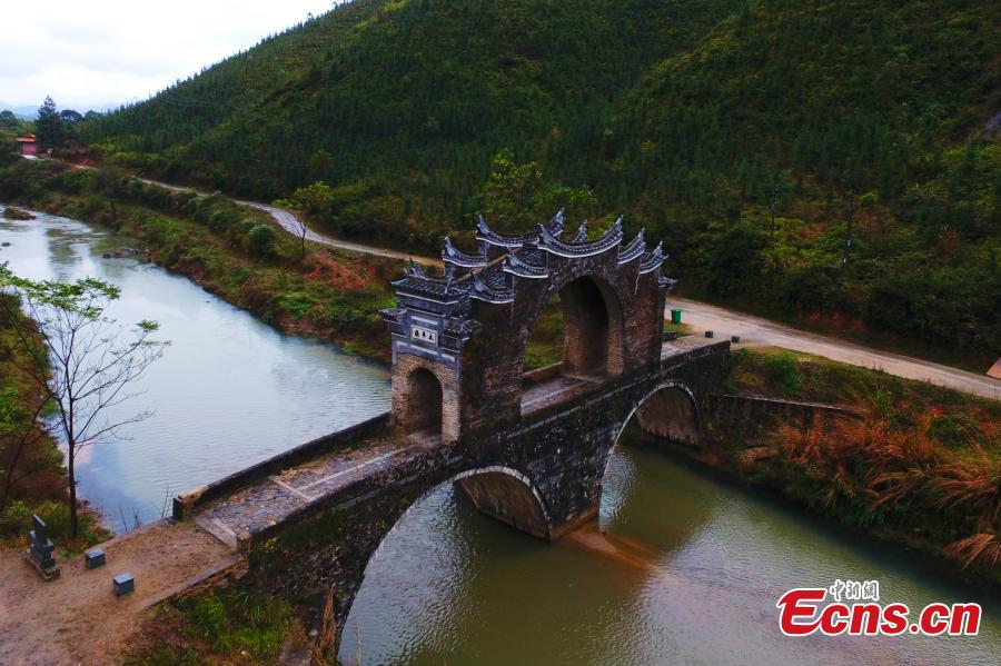 <?php echo strip_tags(addslashes(An aerial view of Taiping Bridge (Peace Bridge) in Longnan County, Jiangxi Province, Dec. 9, 2018. The double-layered stone bridge has two archways at the bottom and one on the top, a rare design. Built during the Ming Dynasty (1368-1644), the 50-meter-long bridge is now a cultural relic under national protection. (Photo: China News Service/Liu Zhankun))) ?>