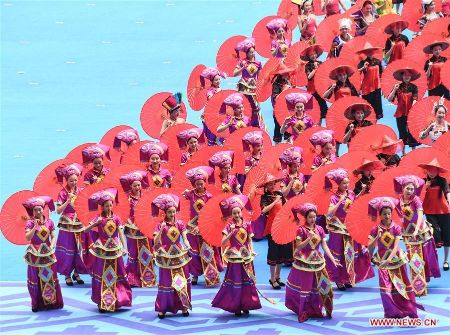Dancers perform in a grand gathering held to celebrate the 60th anniversary of the founding of south China\'s Guangxi Zhuang Autonomous Region in Nanning, capital of Guangxi, Dec. 10, 2018. (Xinhua/Shen Hong)