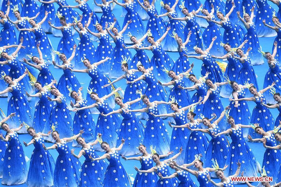 Dancers perform in a grand gathering held to celebrate the 60th anniversary of the founding of south China\'s Guangxi Zhuang Autonomous Region in Nanning, capital of Guangxi, Dec. 10, 2018. (Xinhua/Li Xin)