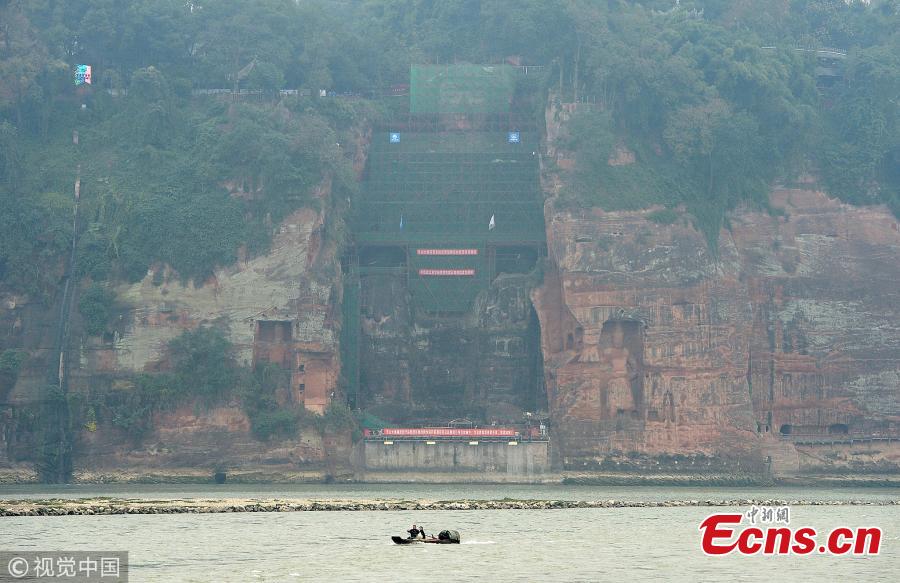 <?php echo strip_tags(addslashes(A 71-meter-tall Buddha statue-enclosed by scaffolding in the Leshan Giant Buddha Scenic Zone in Leshan, Sichuan province-has been undergoing repairs and maintenance since Oct 8. The price of entrance tickets to the scenic zone were cut by half on Monday because of the work, according to its administrative committee.(Photo/VCG))) ?>