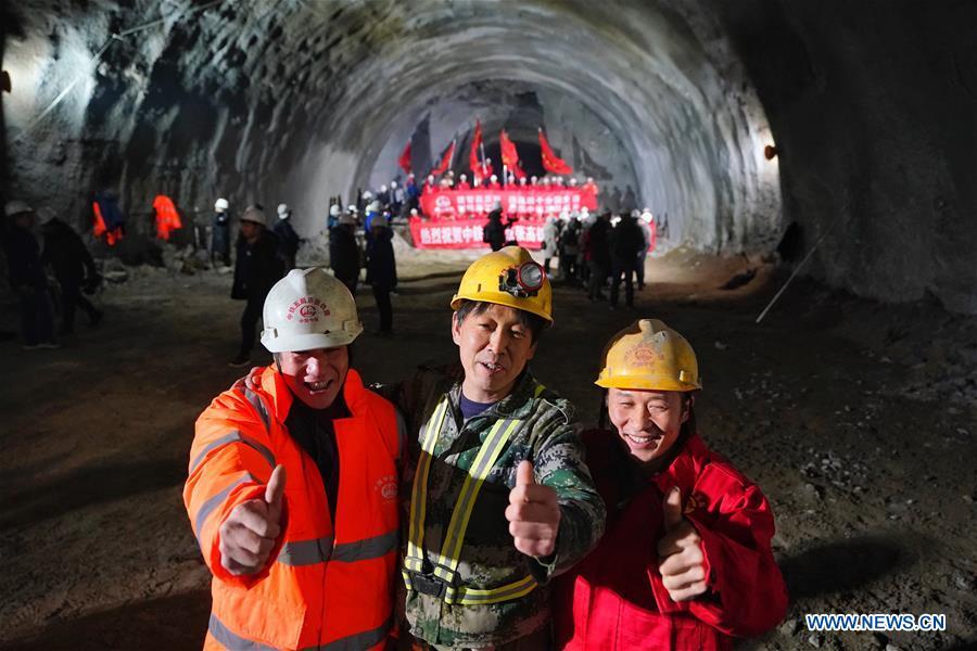 Workers celebrate as they cut through the New Badaling tunnel of the Beijing-Zhangjiakou high-speed rail line in Beijing, capital of China, Dec. 13, 2018. Workers have achieved a major breakthrough in the Beijing-Zhangjiakou high-speed rail line project, after they dug through the New Badaling tunnel, a pivotal part along the line, on Thursday. (Xinhua/Xing Guangli)