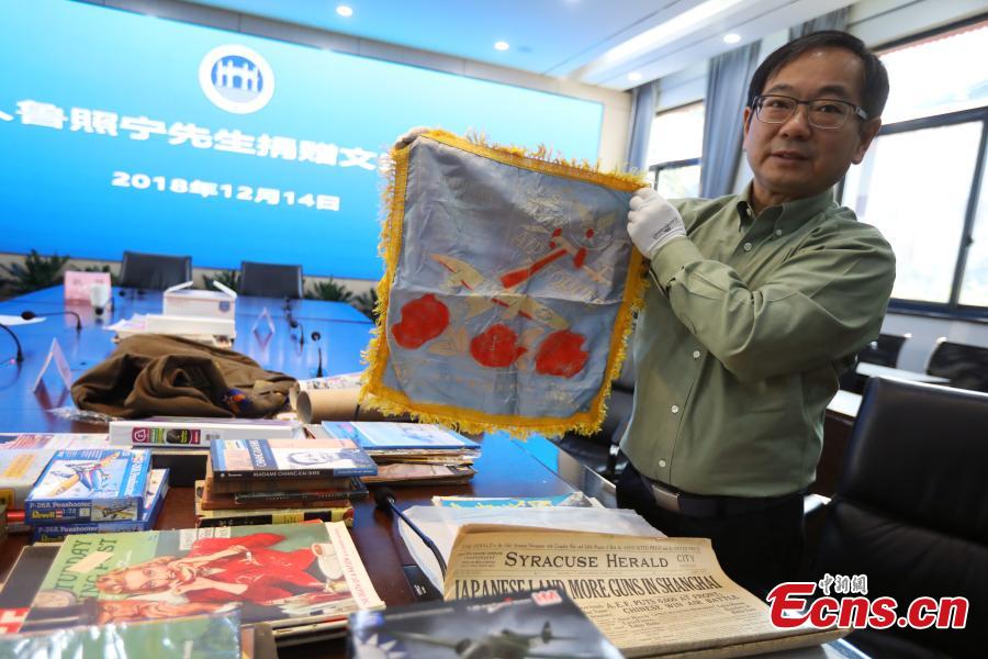 <?php echo strip_tags(addslashes(Chinese-American Lu Zhaoning donates historical materials to the Memorial Hall of the Aviator Martyrs in the War of Resistance against Japanese Aggression in Nanjing City, Jiangsu Province, Dec. 14, 2018. The relics included pilot’s suits, books by Flying Tiger pilots and other materials about WWII war planes. Lu’s relative Lu Meiyin served as a flight attendant in the war. The memorial hall shows the names and a basic introduction in Chinese, English and Russian on thousands of pilots from China, the United States and Soviet Union who died in China during the war. (Photo: China News Service/Yang Bo))) ?>