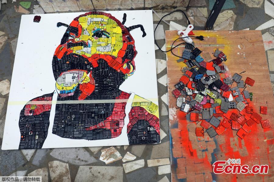 <?php echo strip_tags(addslashes(An artwork made with discarded phone keyboards is pictured at the workshop of 24-year-old artist Desire Koffi, in Abidjan, Ivory Coast Dec. 3, 2018. Desire Koffi often walks through Koumassi, a popular district of Ivory Coast's main city Abidjan, to collect old mobile phones that he buys from people for 500 CFA francs ($0.8726) a pair. Back home, he dismantles the phones with a hammer to pull out the screens and keyboards. He uses them for his paintings. One can take him up to three or five days of work. (Photo/Agencies))) ?>
