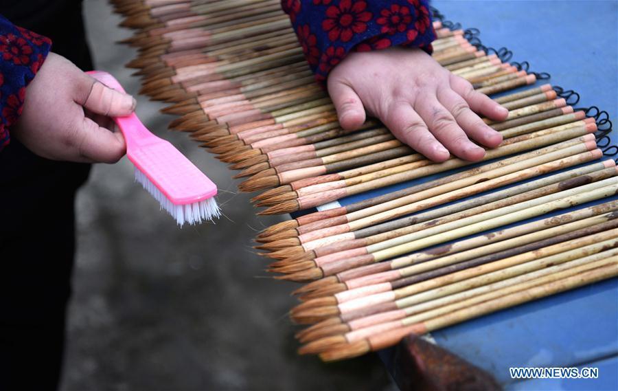 <?php echo strip_tags(addslashes(A worker dries the Xuan ink brushes at a workshop in Huangcun Town of Jingxian County, east China's Anhui Province, Dec. 14, 2018. Huangcun Town has a long history of the Xuan ink brush making. The ink brush, ink, Chinese Xuan paper and ink slabs are four traditional writing materials of Chinese stationery. (Xinhua/Liu Junxi))) ?>