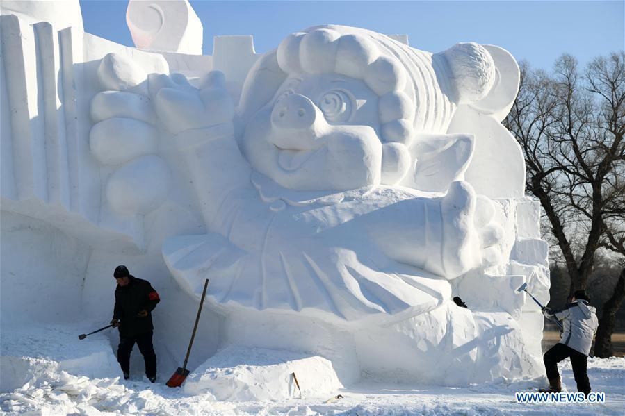 Sculptors carve a snow sculpture with \