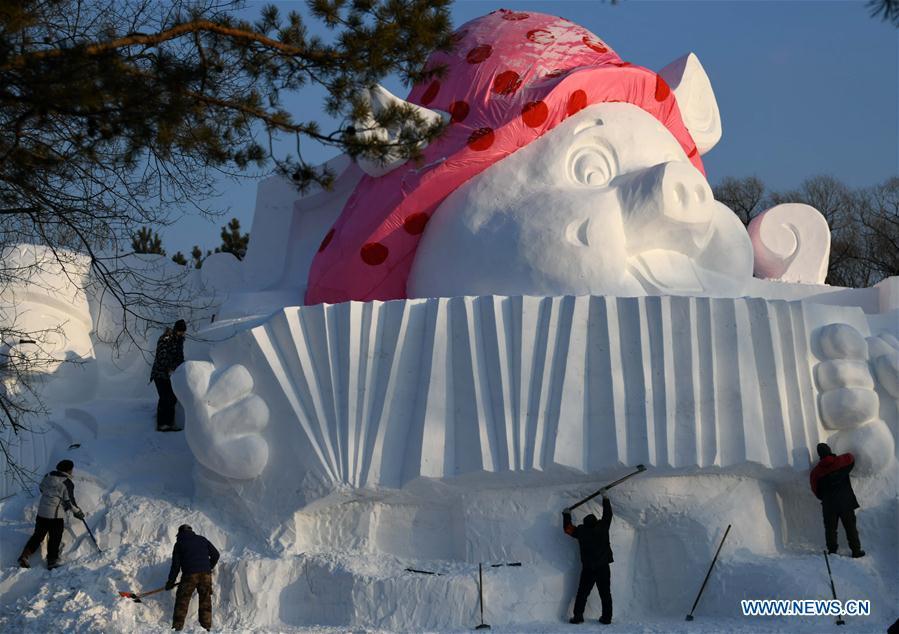 Sculptors carve a snow sculpture with \