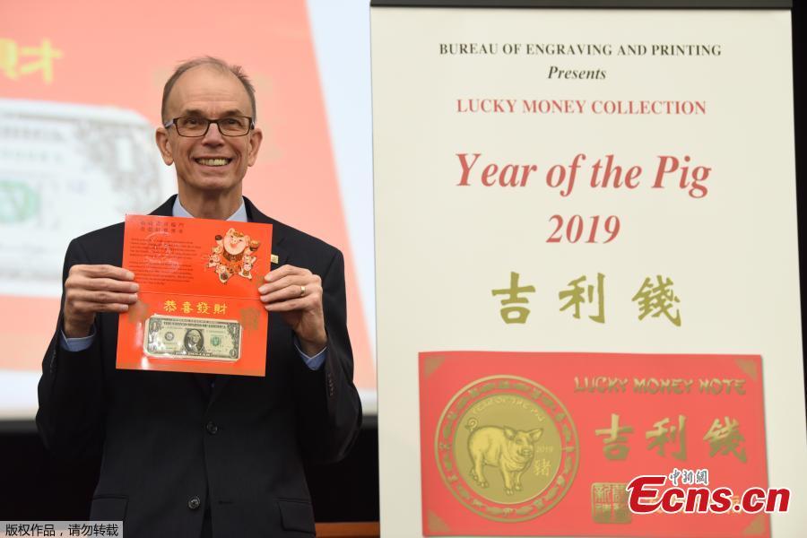 The Year of the Pig 2019 dollar bill in honor of the Chinese Lunar New Year is introduced at the Bureau of Engraving and Printing in Washington, DC, on December 17, 2018. Leonard Olijar, Director of the Bureau of Engraving and Printing, unveiled the Year of the Pig 2019 $1 Federal Reserve note with a serial number beginning with \