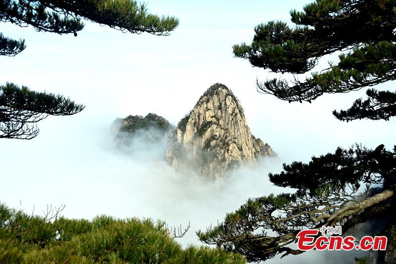 Mist and clouds surround Mount Huangshan in Anhui Province on Dec. 20, 2018. A UNESCO World Heritage site, the area is well known for its scenery, sunsets, peculiarly-shaped granite peaks, and pine trees. (Photo: China News Service/Wang Hui)