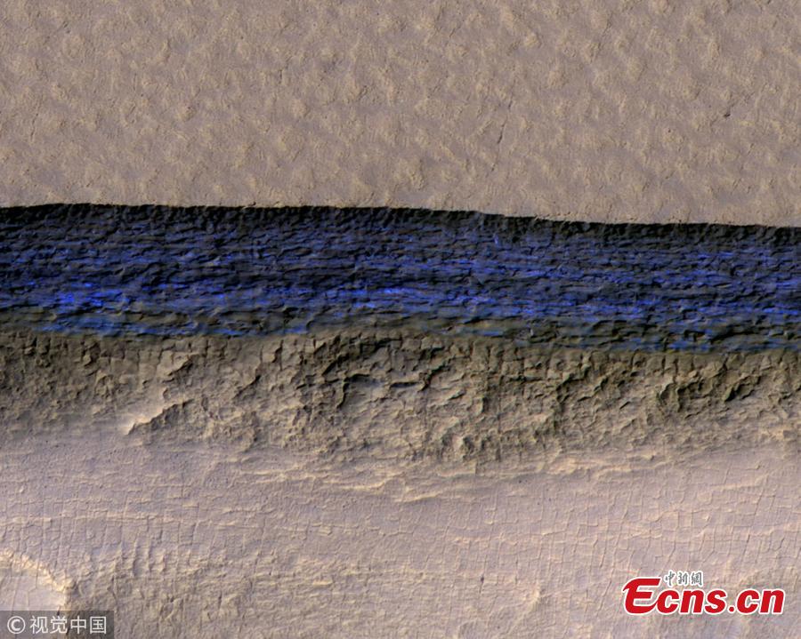 A cross-section of a thick sheet of underground ice is exposed at the steep slope that appears bright blue in this enhanced-color view of Mars from the High Resolution Imaging Science Experiment (HiRISE) camera on NASA\'s Mars Reconnaissance Orbiter in this image released on Jan. 11, 2018. (Photo/Agencies)