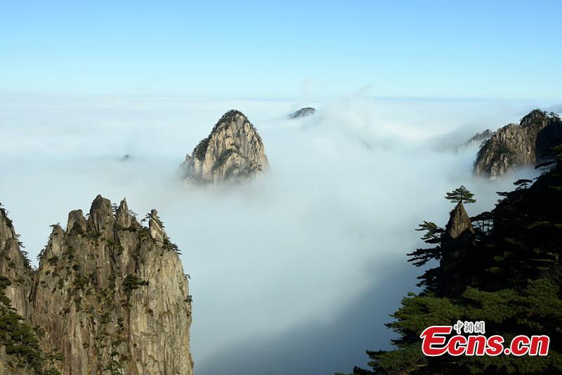 Mist and clouds surround Mount Huangshan in Anhui Province on Dec. 20, 2018. A UNESCO World Heritage site, the area is well known for its scenery, sunsets, peculiarly-shaped granite peaks, and pine trees. (Photo: China News Service/Wang Hui)