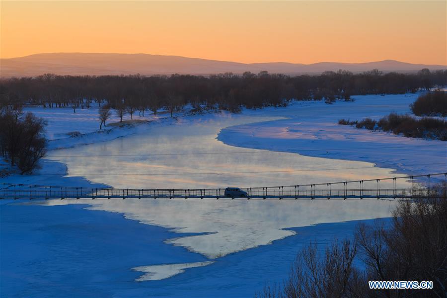 A car runs on a bridge spans Ertix River in Burqin County, northwest China\'s Xinjiang Uygur Autonomous Region, Dec. 21, 2018. Burqin County, home to the region\'s renowned Kanas Lake, which takes tourism as its pillar industry speeds up the development of local tourism from single scenic spot to holiday resort in recent years. (Xinhua/Liu Dawei)
