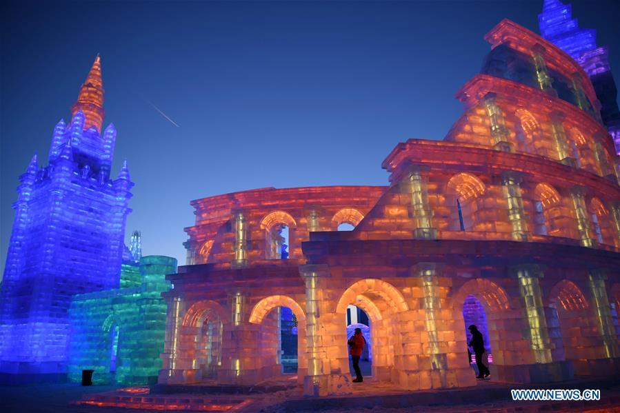 Tourists visit the Ice-Snow World in Harbin, capital of northeast China\'s Heilongjiang Province, Dec. 23, 2018. The Ice-Snow World opened on Sunday in Harbin. Covering an area of 600,000 square meters, the park used 110,000 cubic meters of ice and 120,000 cubic meters of snow this year. (Xinhua/Wang Jianwei)