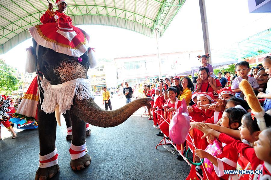 <?php echo strip_tags(addslashes(An elephant distributes gifts to students during Christmas celebrations at a school in Ayutthaya province, Thailand, Dec. 24, 2018. The annual event is held to celebrate Christmas and promote tourism in Ayutthaya. (Xinhua/Rachen Sageamsak))) ?>