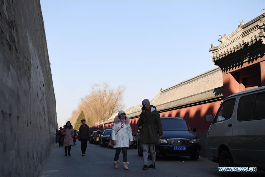 Tourists walk past the wall of the Palace Museum in Beijing, capital of China, Jan. 1, 2019. In order to further enhance visiting experiences and loosen pressure on exits, starting from Jan. 1, 2019, the museum will open the area between its northern Gate of Divine Prowess (Shenwu) and eastern Gate of East Glory (Donghua). (Xinhua/Jin Liangkuai)