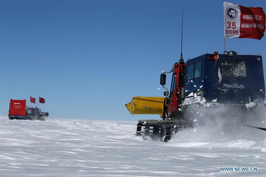 Tractors of China\'s 35th Antarctic expedition team run through ice knolls in Antarctica on Dec. 31, 2018. The expedition team, expected to arrive at Kunlun Station in five days at about 4,000 meters above the sea level near Dome A, entered into the Antarctic Plateau on Monday. (Xinhua/Liu Shiping)