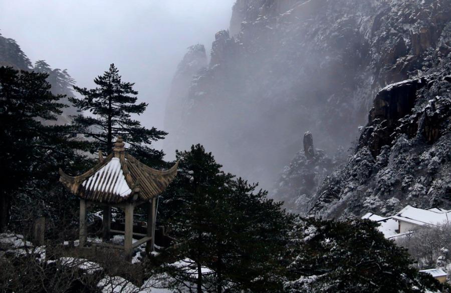 Huangshan Mountain scenic area in Anhui province is shrouded in a mantle of white after a snowfall, Jan. 1, 2019. Clouds and misty air envelop the towering mountain peaks, creating a breathtakingly beautiful scene. (Photo/Asianewsphoto)