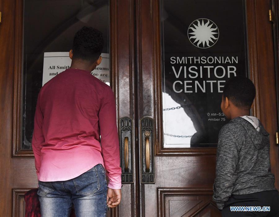 <?php echo strip_tags(addslashes(People stand in front of the closed doors of the Smithsonian Institution Building's visitor center in Washington D.C., the United States, on Jan. 2, 2019. The 19 Smithsonian museums and the National Zoo in Washington D.C. closed their doors on Wednesday as the partial U.S. government shutdown dragged on. (Xinhua/Liu Jie))) ?>