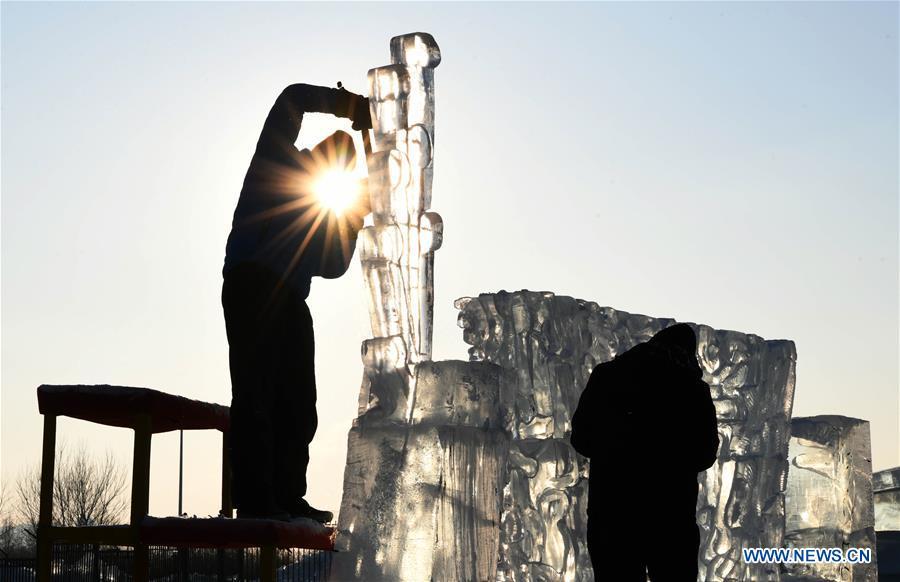 Contestants carve an ice sculpture during an international ice sculpture competition in Harbin, capital of northeast China\'s Heilongjiang Province, Jan. 2, 2019. A total of 16 teams from 12 countries and regions took part in the competition. (Xinhua/Wang Jianwei)