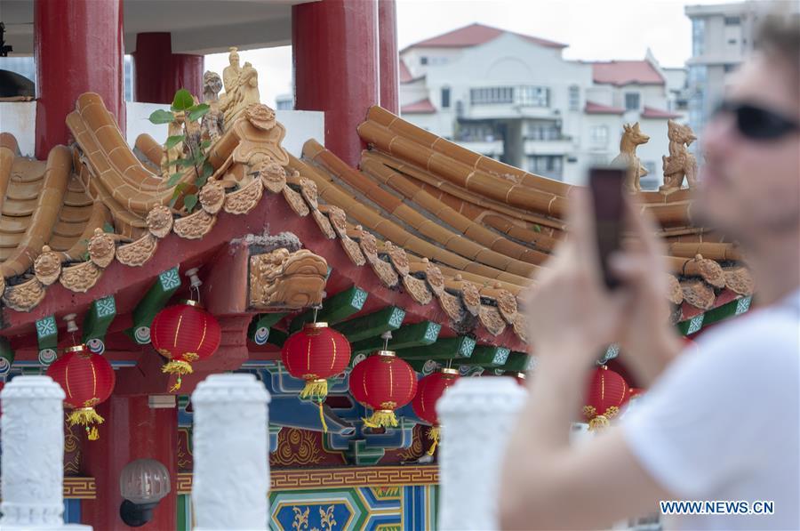 A tourist visits the Thean Hou Temple as lanterns are prepared in celebration of the upcoming Chinese lunar New Year in Kuala Lumpur, Malaysia, Jan. 3, 2019. (Xinhua/Chong Voon Chung)