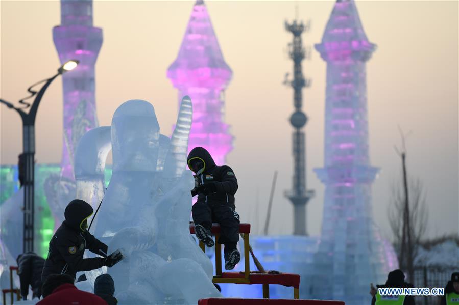 Contestants carve an ice sculpture during an international ice sculpture competition in Harbin, capital of northeast China\'s Heilongjiang Province, Jan. 3, 2019. (Xinhua/Wang Song)