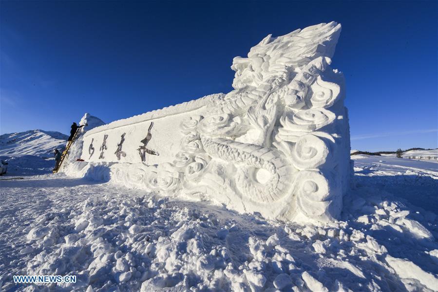 People create a snow sculpture for Hom scenic area in Kanas, northwest China\'s Xinjiang Uygur Autonomous Region, Jan. 2, 2019. Kanas scenic spot attracts lots of visitors in winter with its pure snow scenery and various entertainment. (Xinhua/Hu Huhu)