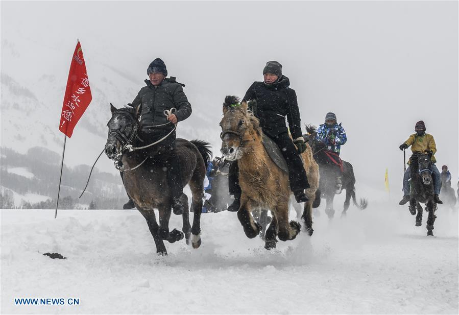 Local residents perform horse riding in snow in Hom scenic area of Kanas, northwest China\'s Xinjiang Uygur Autonomous Region, Jan. 1, 2019. Kanas scenic spot attracts lots of visitors in winter with its pure snow scenery and various entertainment. (Xinhua/Zhao Ge)