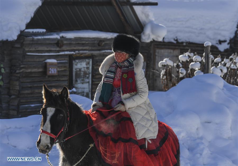 A visitor rides a horse in Kanas, northwest China\'s Xinjiang Uygur Autonomous Region, Jan. 2, 2019. Kanas scenic spot attracts lots of visitors in winter with its pure snow scenery and various entertainment. (Xinhua/Hu Huhu)