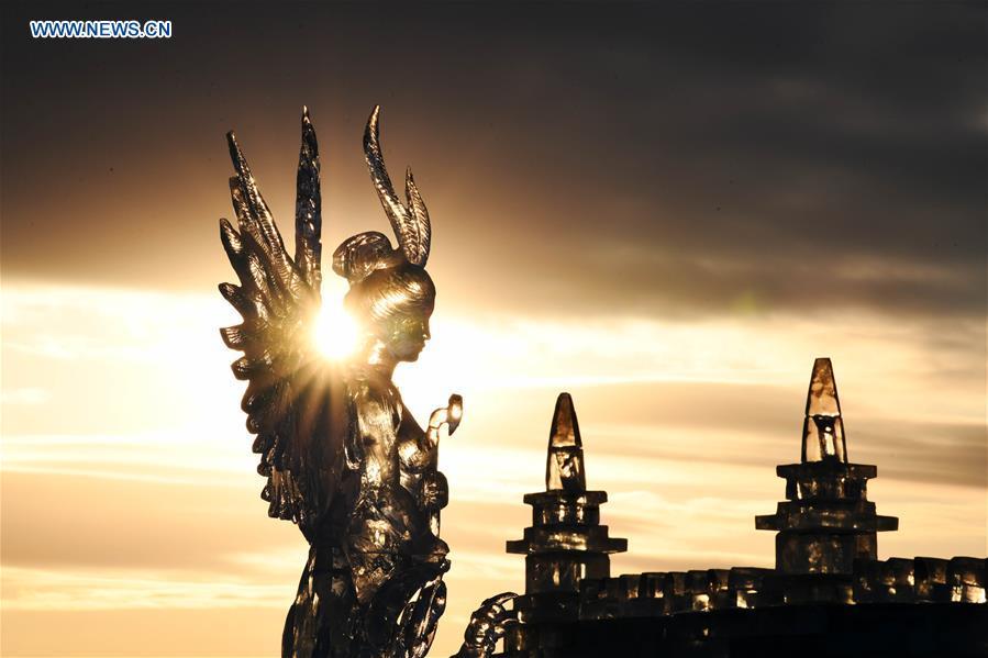 Photo taken on Jan. 4, 2019 shows an ice sculpture work at sunset during an international ice sculpture competition in Harbin, capital of northeast China\'s Heilongjiang Province. The competition concluded on Friday. (Xinhua/Wang Jianwei)