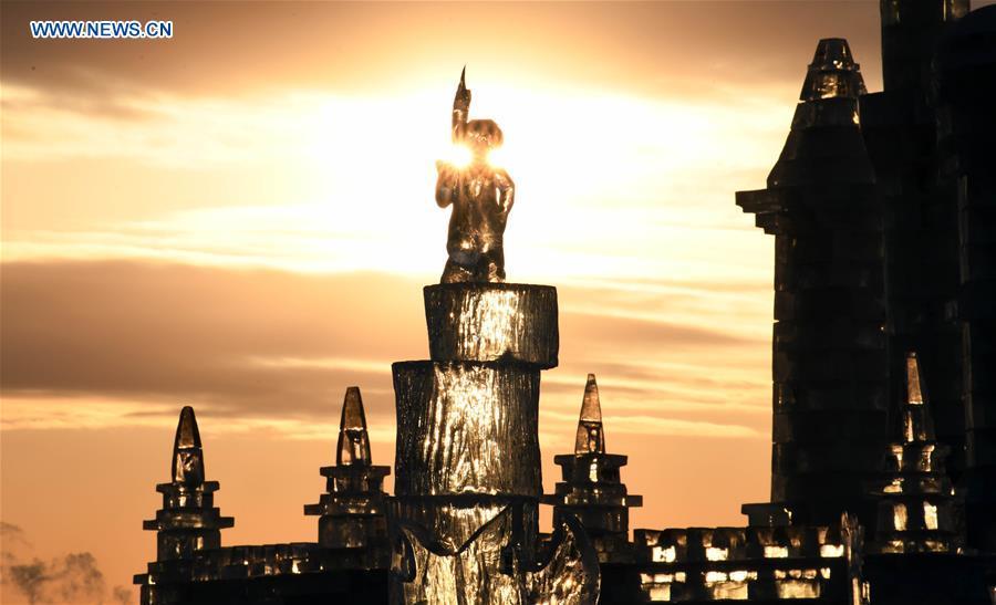 Photo taken on Jan. 4, 2019 shows an ice sculpture work at sunset during an international ice sculpture competition in Harbin, capital of northeast China\'s Heilongjiang Province. The competition concluded on Friday. (Xinhua/Wang Jianwei)