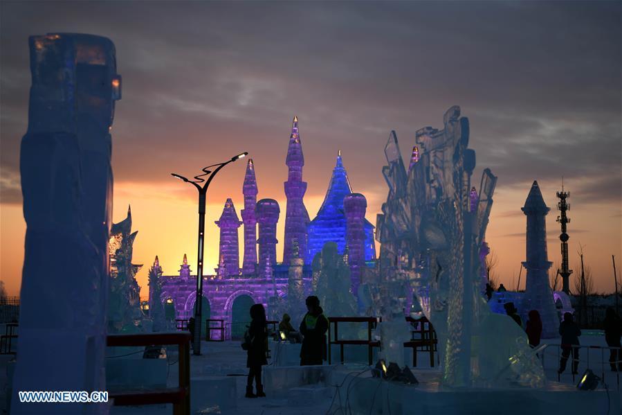 Photo taken on Jan. 4, 2019 shows an ice sculpture work at sunset during an international ice sculpture competition in Harbin, capital of northeast China\'s Heilongjiang Province. The competition concluded on Friday. (Xinhua/Wang Jianwei)