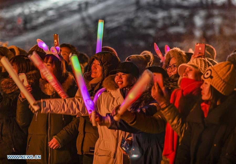 Photo taken on Dec. 31, 2018 shows visitors celebrating the New Year during a bonfire party in Hom scenic area of Kanas, northwest China\'s Xinjiang Uygur Autonomous Region. Kanas scenic spot attracts lots of visitors in winter with its pure snow scenery and various entertainment. (Xinhua/Zhao Ge)