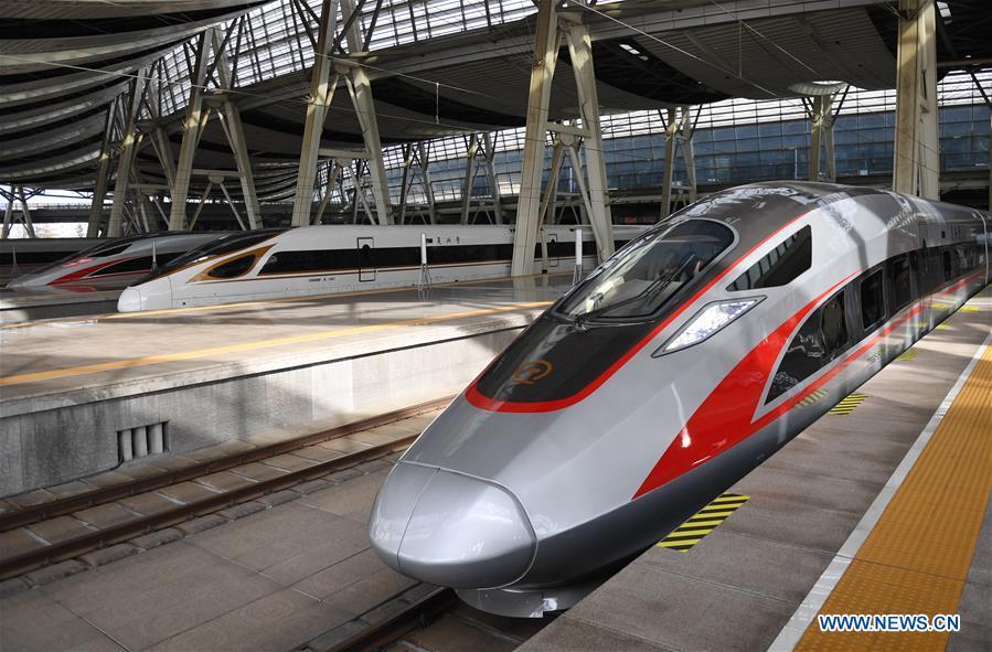 Photo taken on Jan. 5, 2019 shows a new Fuxing bullet train (R) at Beijing South Railway Station in Beijing, capital of China. A longer Fuxing bullet train started running on the Beijing-Shanghai line Saturday at noon. The new train, with a designed speed of 350 km per hour, has 17 carriages, one carriage longer than the Fuxing trains currently in use. (Xinhua/Zhang Chenlin)