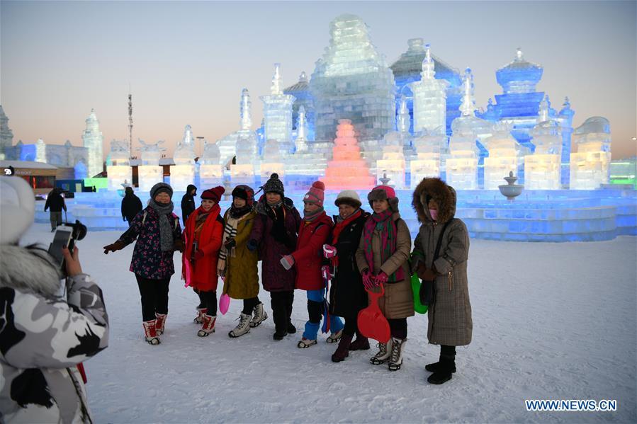 Tourists pose for a group photo at the Ice-Snow World in Harbin, capital of northeast China\'s Heilongjiang Province, Jan. 5, 2019. The 35th Harbin International Ice and Snow Festival kicked off here on Saturday. (Xinhua/Wang Song)