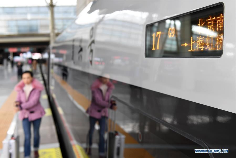 Passengers board on a new Fuxing bullet train at Beijing South Railway Station in Beijing, capital of China, Jan. 5, 2019. A longer Fuxing bullet train started running on the Beijing-Shanghai line Saturday at noon. The new train, with a designed speed of 350 km per hour, has 17 carriages, one carriage longer than the Fuxing trains currently in use. (Xinhua/Zhang Chenlin)