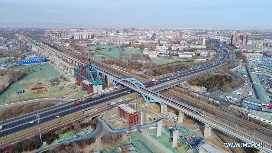 Photo taken on Jan. 5, 2019 shows a new Fuxing bullet train running past Huangcun bridge in Beijing, capital of China. A longer Fuxing bullet train started running on the Beijing-Shanghai line Saturday at noon. The new train, with a designed speed of 350 km per hour, has 17 carriages, one carriage longer than the Fuxing trains currently in use. (Xinhua/Xing Guangli)