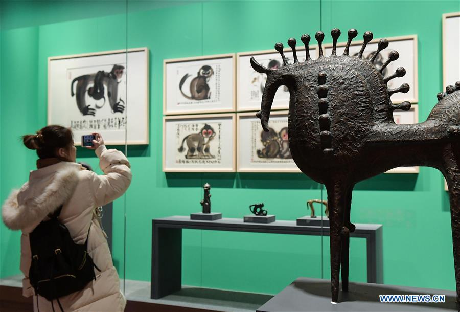 A visitor views Han Meilin\'s Chinese Zodiac Art Exhibition in Beijing, capital of China, Jan. 5, 2019. The Chinese Zodiac Art Exhibition, displaying the fine arts of Chinese artist Han Meilin, kicked off in the Palace Museum on Saturday and will last until Feb. 20, 2019. (Xinhua/Li He)