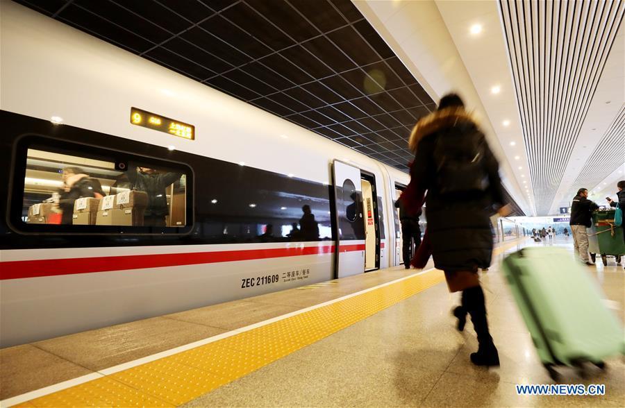 A passenger boards on a new Fuxing bullet train at Shanghai Hongqiao Railway Station in Shanghai, east China, Jan. 5, 2019. A longer Fuxing bullet train started running on the Beijing-Shanghai line Saturday at noon. The new train, with a designed speed of 350 km per hour, has 17 carriages, one carriage longer than the Fuxing trains currently in use. (Xinhua/Fang Zhe)