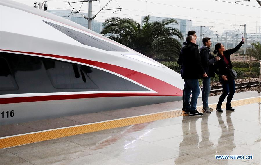 Passengers take selfie with a new Fuxing bullet train at Shanghai Hongqiao Railway Station in Shanghai, east China, Jan. 5, 2019. A longer Fuxing bullet train started running on the Beijing-Shanghai line Saturday at noon. The new train, with a designed speed of 350 km per hour, has 17 carriages, one carriage longer than the Fuxing trains currently in use. (Xinhua/Fang Zhe)