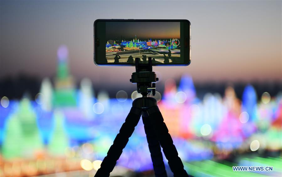 A tourist takes photo of the Ice-Snow World in Harbin, capital of northeast China\'s Heilongjiang Province, Jan. 5, 2019. The 35th Harbin International Ice and Snow Festival kicked off here on Saturday. (Xinhua/Wang Jianwei)