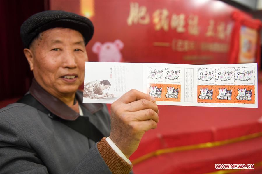 A citizen presents special zodiac stamps for the lunar year of the Pig in Hefei, capital of east China\'s Anhui Province, Jan. 5, 2019. China Post on Saturday issued a set of special zodiac stamps in honor of 2019 Chinese Lunar New Year, or the Year of the Pig. The Year of the Pig starts from Feb. 5, 2019. (Xinhua/Zhang Duan)