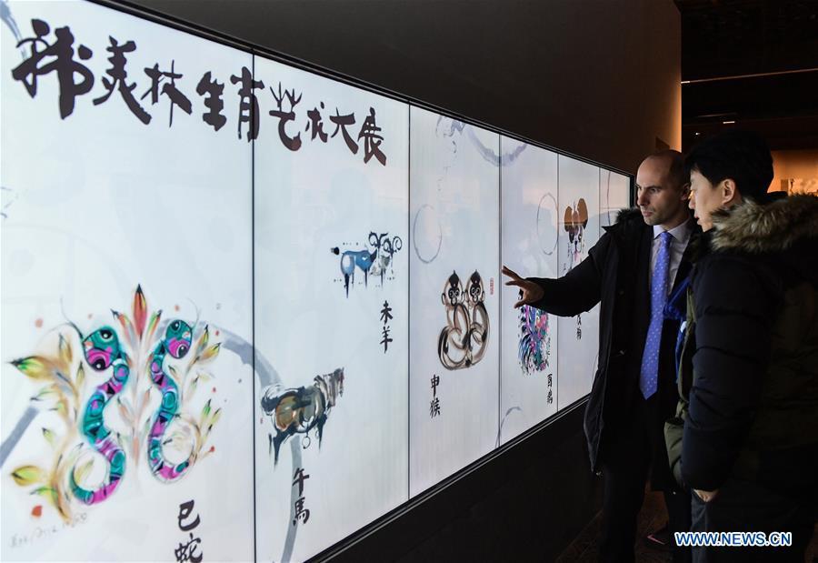 Visitors view Han Meilin\'s Chinese Zodiac Art Exhibition in Beijing, capital of China, Jan. 5, 2019. The Chinese Zodiac Art Exhibition, displaying the fine arts of Chinese artist Han Meilin, kicked off in the Palace Museum on Saturday and will last until Feb. 20, 2019. (Xinhua/Li He)