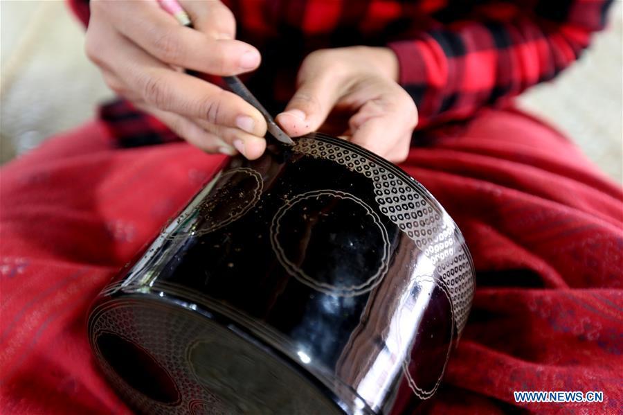 A worker makes lacquerware at a workshop in Bagan, Mandalay Region of Myanmar, on Jan. 7, 2019. Lacquerware is one of Myanmar\'s traditional handicrafts and popular souvenirs for tourists. It is made of strips of bamboo, hair of horse tail and wood. (Xinhua/U Aung)