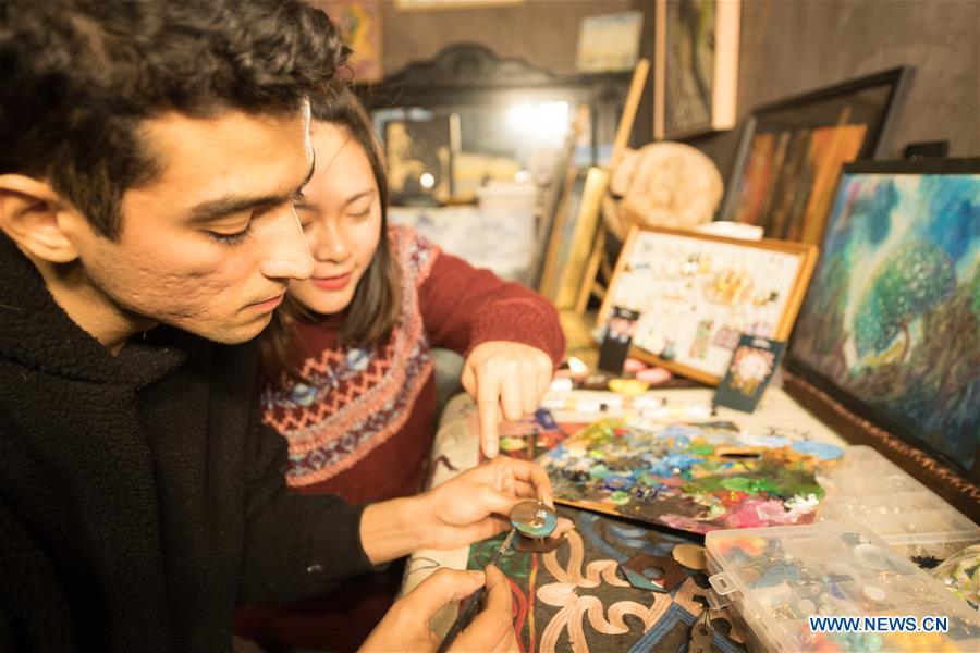 Mehraz Karami (L) paints on an ornament designed by his girlfriend Chen Xiaoqiong (R) at his workshop in Shanbei Village in Daixi Town of Huzhou City, east China\'s Zhejiang Province, on Jan. 7, 2019. Iranian Mehraz Karami, who was born in Tehran in 1993, has shown his interest in Chinese culture ever since his childhood. He came to Daixi Town and set up his own painting workshop at the end of 2017 after graduation from east China\'s Shanghai. He said he hoped to stay in China and become an artist. (Xinhua/Weng Xinyang)