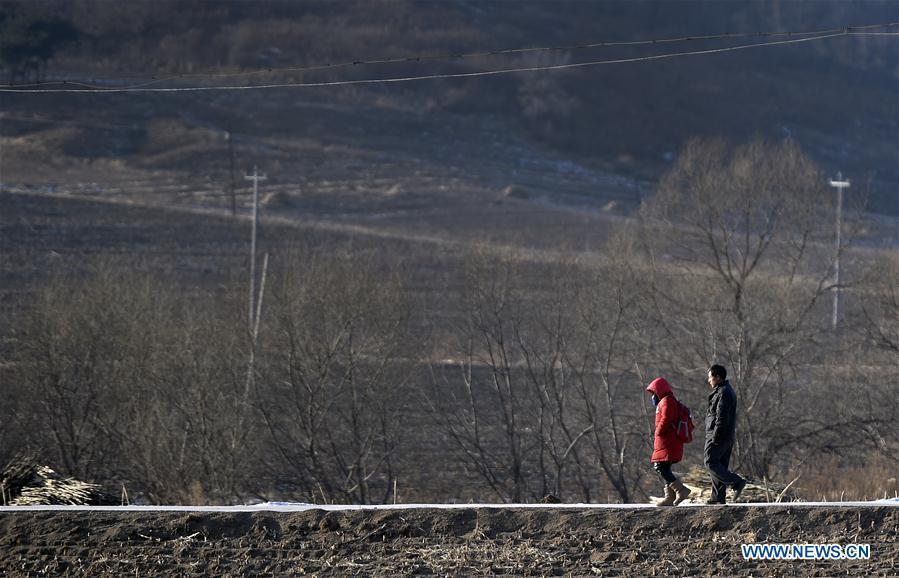 Hu Zhisheng walks his student Sun Xiaofeng way home after school in Yantai Village of Lianhua Township in Tieling City, northeast China\'s Liaoning Province, Jan. 7, 2019. Located in a remote mountain village, most students of Yantai school had transferred to other places outside the mountain. Sun Xiaofeng, a third grade student, became the only student of the school in September last year taught by Hu Zhisheng, the only one faculty of Yantai primary school. (Xinhua/Yao Jianfeng)