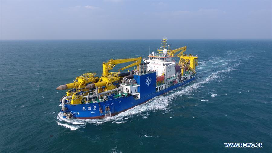 <?php echo strip_tags(addslashes(Chinese-built dredging vessel Tian Kun Hao is seen sailing on the sea on Jan. 8, 2019. Tian Kun Hao, a Chinese-built dredging vessel, which is the largest of its kind in Asia, returned to the shipyard Wednesday after completing its sea trial of nearly three months. The 140-meter-long, 27.8-meter-wide vessel can dig as deep as 35 meters under the sea floor and dredge 6,000 cubic meters per hour, according to its investor, Tianjin Dredging Co., a subsidiary of China Communication Construction Co. (Xinhua))) ?>