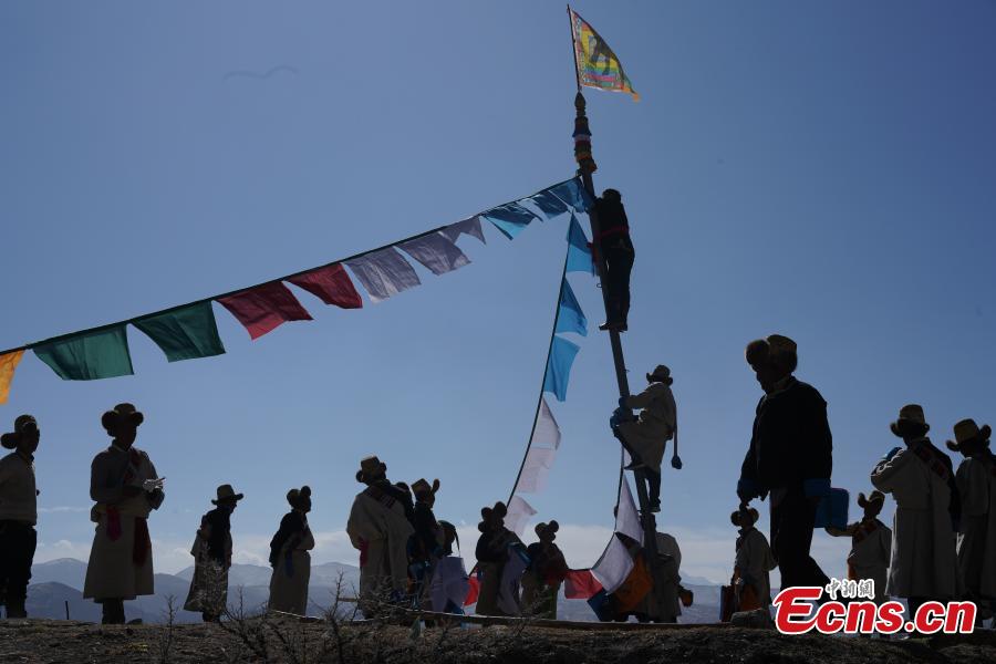 <?php echo strip_tags(addslashes(Tibetans hang prayer flags as part of celebrations for the New Year in the Tibetan calendar in Nyemo County, Southwest China's Tibet Autonomous region. In traditional highland barley farming areas, including Nyemo County, locals have a tradition of celebrating the Tibetan New Year one month early, so the celebrations do not affect farming. (Photo: China News Service/Sangdan Pingcuo))) ?>