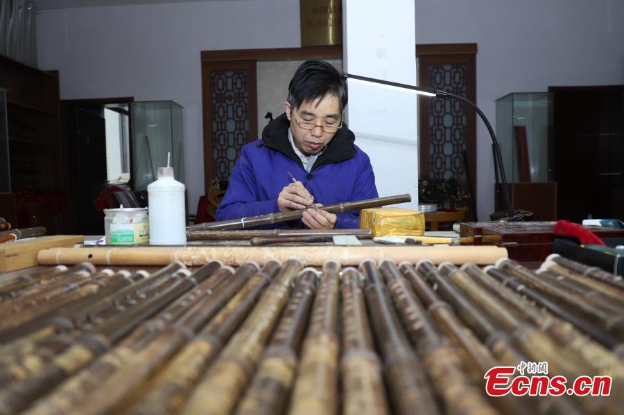 Wu Jihong, an inheritor of the Yuping bamboo -flute making craft, works to make a flute in Yuping Dong Autonomous County, Southwest China\'s Guizhou Province, Jan. 10, 2019. As a traditional Chinese bamboo instrument, the Yuping bamboo flute is famous for its clear tone and delicate carving. Made from local bamboo, the flute undergoes dozens of procedures before it is finished and merges folk cultures of several ethnic groups. It was listed as one of the National Intangible Cultural Heritages in 2006. (Photo: China News Service/Qu Honglun)