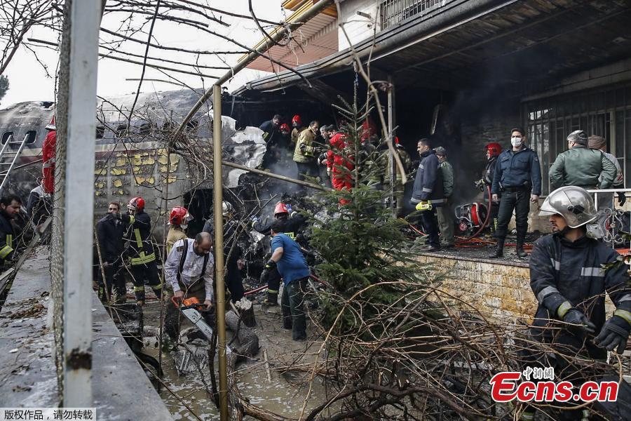 Firefighters and security forces gather amidst the debris of a Boeing 707 cargo plane that reportedly crashed into a residential complex near the Iranian capital Tehran with more than 10 people onboard on January 14, 2019. The plane overshot the runway during its landing, Iran\'s aviation organisation spokesman Reza Jafarzadeh told state broadcaster IRIB. (Photo/Agencies)