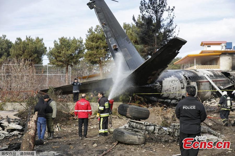 Firefighters and security forces gather amidst the debris of a Boeing 707 cargo plane that reportedly crashed into a residential complex near the Iranian capital Tehran with more than 10 people onboard on January 14, 2019. The plane overshot the runway during its landing, Iran\'s aviation organisation spokesman Reza Jafarzadeh told state broadcaster IRIB. (Photo/Agencies)
